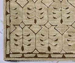 An artisan carefully trimming the pile of a finished rug for a perfect surface.