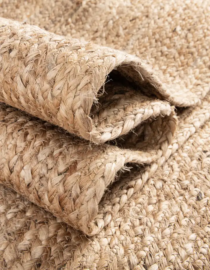 A rustic jute rug with a thick, braided texture